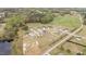 Aerial view of a quaint community featuring well-kept homes, lush trees, and a scenic pond at 127 Hurricane Aly, Benson, NC 27504