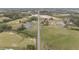 Open aerial view showcases an expansive rural landscape, distant water tower, and a straight road stretching to the horizon at 127 Hurricane Aly, Benson, NC 27504