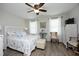 Bright bedroom showcasing a decorative white headboard, neutral walls, and hardwood floors at 127 Hurricane Aly, Benson, NC 27504