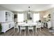 Inviting dining area featuring wood floors, white furniture, and plenty of natural light at 127 Hurricane Aly, Benson, NC 27504