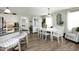 Bright dining room with a classic white table set, accented by a modern light fixture at 127 Hurricane Aly, Benson, NC 27504