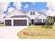 Charming two-story home with a manicured lawn, two-car garage, and inviting front porch, perfect for curb appeal at 127 Hurricane Aly, Benson, NC 27504