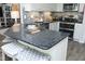Kitchen island featuring granite countertops, stylish backsplash, and seating at 127 Hurricane Aly, Benson, NC 27504