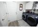 Functional laundry room with washer, dryer, and cabinet storage at 127 Hurricane Aly, Benson, NC 27504