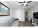 Well-lit living room featuring hardwood floors, neutral walls, a sofa, and a ceiling fan at 127 Hurricane Aly, Benson, NC 27504