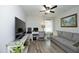 Well-lit living room featuring hardwood floors, neutral walls, a sofa, and a ceiling fan at 127 Hurricane Aly, Benson, NC 27504