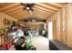 Well-lit shed interior with worktable, shelving, ceiling fan, and ample storage space at 127 Hurricane Aly, Benson, NC 27504