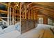 Unfinished attic space displaying the home's frame construction with a single window at 128 School Side Dr, Spring Lake, NC 28390