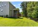 Spacious backyard with a well-maintained lawn and screened-in porch overlooking the green space at 128 School Side Dr, Spring Lake, NC 28390