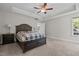 Cozy main bedroom featuring neutral colors, a ceiling fan and a private ensuite bathroom at 128 School Side Dr, Spring Lake, NC 28390
