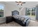 Bedroom featuring a ceiling fan, bedside table, and large window at 128 School Side Dr, Spring Lake, NC 28390