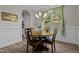 Elegant dining room featuring wainscoting, a modern chandelier and a backyard view at 128 School Side Dr, Spring Lake, NC 28390