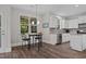 Breakfast nook with modern lighting and a view, adjacent to kitchen with granite countertops at 128 School Side Dr, Spring Lake, NC 28390