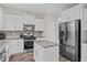 Modern kitchen with stainless steel appliances, subway tile backsplash and a center island at 128 School Side Dr, Spring Lake, NC 28390