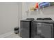 Laundry room with grey washer and dryer and white shelving at 128 School Side Dr, Spring Lake, NC 28390