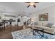 Open concept living room with wood floors that flow into the kitchen and dining area at 128 School Side Dr, Spring Lake, NC 28390