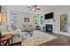 Bright living room with dark wood floors, a fireplace, recessed lighting, and an outdoor view at 128 School Side Dr, Spring Lake, NC 28390