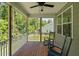 Relaxing screened-in porch featuring wood floors and comfortable rocking chairs at 128 School Side Dr, Spring Lake, NC 28390