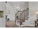 Elegant staircase featuring wood and wrought iron design that leads to the upper level at 128 School Side Dr, Spring Lake, NC 28390