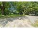 Large gravel parking pad with grass yard creates an ideal space for entertaining at 129 Burwell Avenue Ave, Henderson, NC 27536