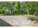Large gravel parking pad and expansive lawn create an ideal space for entertaining at 129 Burwell Avenue Ave, Henderson, NC 27536
