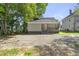Back of house showing small porch and ample parking with trees and shrubbery at 129 Burwell Avenue Ave, Henderson, NC 27536