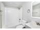 Modern bathroom featuring a shower and bath with subway tile, and sleek fixtures at 129 Burwell Avenue Ave, Henderson, NC 27536