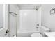 Bright bathroom featuring a shower and bath with subway tile, and sleek fixtures at 129 Burwell Avenue Ave, Henderson, NC 27536