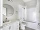 Clean and modern bathroom features a vanity with a round mirror, a shower, and tile flooring at 129 Burwell Avenue Ave, Henderson, NC 27536