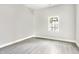 Bright bedroom featuring grey vinyl floors, neutral paint and a view to the outdoors at 129 Burwell Avenue Ave, Henderson, NC 27536