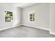 Bright bedroom featuring grey vinyl floors, neutral paint and a view to the outdoors at 129 Burwell Avenue Ave, Henderson, NC 27536