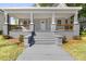 Charming front porch with gray stairs, railings, and white columns offers a welcoming entrance at 129 Burwell Avenue Ave, Henderson, NC 27536