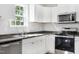 Updated kitchen with stainless steel appliances, gray countertops, and ample storage at 129 Burwell Avenue Ave, Henderson, NC 27536