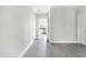 Bright and airy living room featuring gray flooring and an open view to the kitchen with stainless steel appliances at 129 Burwell Avenue Ave, Henderson, NC 27536