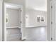 Bright living room with new grey flooring, white walls, and multiple windows letting in natural light at 129 Burwell Avenue Ave, Henderson, NC 27536