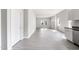 Open-concept living space with modern kitchen and grey hardwood floors with ample lighting at 129 Burwell Avenue Ave, Henderson, NC 27536