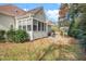 A home's screened porch extends to a patio with a hot tub next to a small storage building at 1312 Golden Bluff Ln, Fuquay Varina, NC 27526