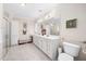 Bright bathroom with double vanity, storage, a large mirror, and tile flooring at 1312 Golden Bluff Ln, Fuquay Varina, NC 27526