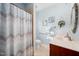 Bathroom with tile flooring, wooden vanity, and decorative mirror at 1312 Golden Bluff Ln, Fuquay Varina, NC 27526