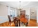 Formal dining room with hardwood floors, elegant chandelier, and large windows at 1312 Golden Bluff Ln, Fuquay Varina, NC 27526