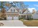 Charming two-story home featuring brick and siding, a two-car garage, and manicured landscaping at 1312 Golden Bluff Ln, Fuquay Varina, NC 27526