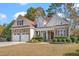 Charming two-story home featuring brick and siding, a two-car garage, and manicured landscaping at 1312 Golden Bluff Ln, Fuquay Varina, NC 27526