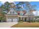 Charming two-story home featuring brick and siding, a two-car garage, and manicured landscaping at 1312 Golden Bluff Ln, Fuquay Varina, NC 27526