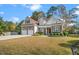 Charming two-story home featuring brick and siding, a two-car garage, and manicured landscaping at 1312 Golden Bluff Ln, Fuquay Varina, NC 27526