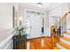 Bright foyer with hardwood floors, staircase, and a view of the living area at 1312 Golden Bluff Ln, Fuquay Varina, NC 27526