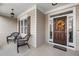 Inviting front porch with seating area and a decorative wreath on the front door at 1312 Golden Bluff Ln, Fuquay Varina, NC 27526