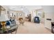 Cozy living room features blue sofa and chair, decorative glass tables, wine rack and views to office at 1312 Golden Bluff Ln, Fuquay Varina, NC 27526