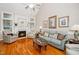 Bright living room features fireplace, hardwood floors, and neutral decor at 1312 Golden Bluff Ln, Fuquay Varina, NC 27526
