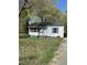 Charming single-story home with vinyl siding, a dark roof, and manicured lawn at 141 N Bullock St, Henderson, NC 27536