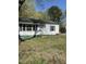 Charming single-story home with vinyl siding, a dark roof, and manicured lawn at 141 N Bullock St, Henderson, NC 27536